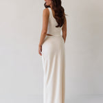 This is the Conrad Set in Ivory. This is a two piece satin set with a fitted, corseted top with thick straps and a delicate tie at the bust and a slight basque waist. It comes with a floor length satin column skirt.