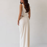 This is the Conrad Set in Ivory. This is a two piece satin set with a fitted, corseted top with thick straps and a delicate tie at the bust and a slight basque waist. It comes with a floor length satin column skirt.