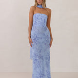 Model wearing a strapless chiffon blue floral dress with a matching scarf. 